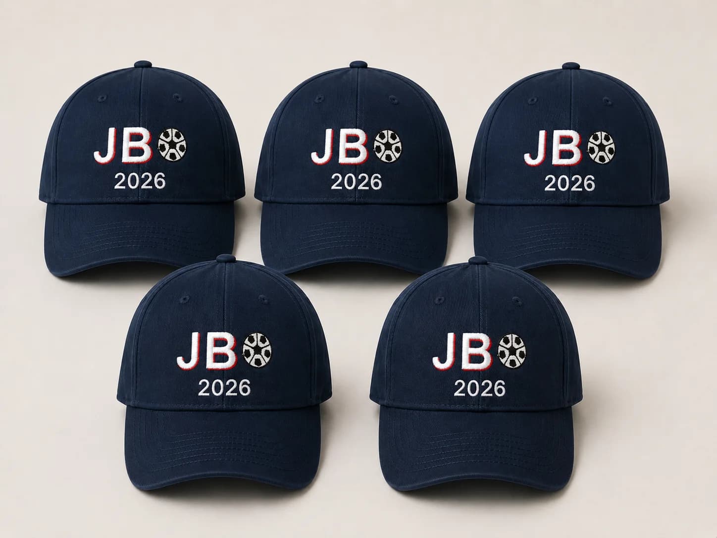 Série de cinq casquettes baseball bleu marine brodées du monogramme JB 2026 et d'un ballon, pour la Coupe du Monde